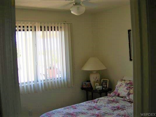 3481 Topaz Road Golden Valley, AZ 86413 - Photo 12 of 12 a bedroom with a bed and a chandelier