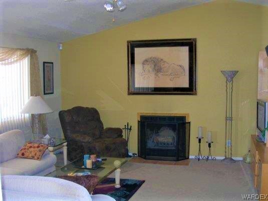 3481 Topaz Road Golden Valley, AZ 86413 - Photo 6 of 12 a living room with furniture and a fireplace