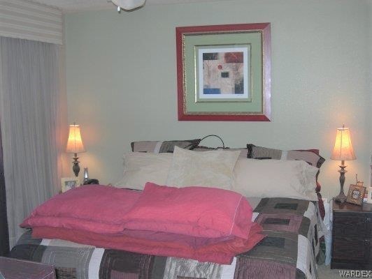 3481 Topaz Road Golden Valley, AZ 86413 - Photo 10 of 12 a bedroom with a bed and wooden floor