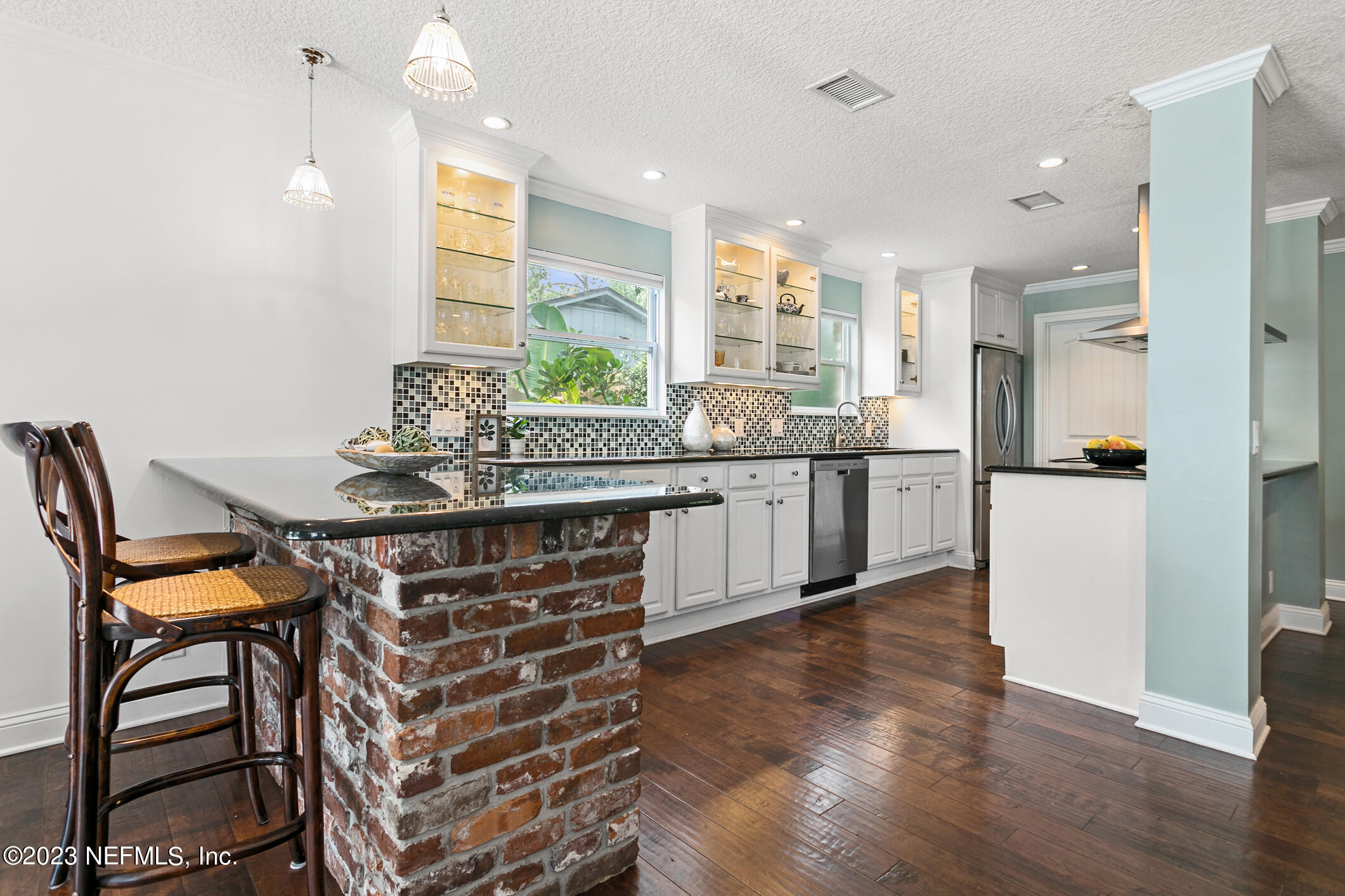 1 Hopson Road Jacksonville Beach, FL 32250 - Photo 11 of 58 a kitchen with a table chairs refrigerator and microwave