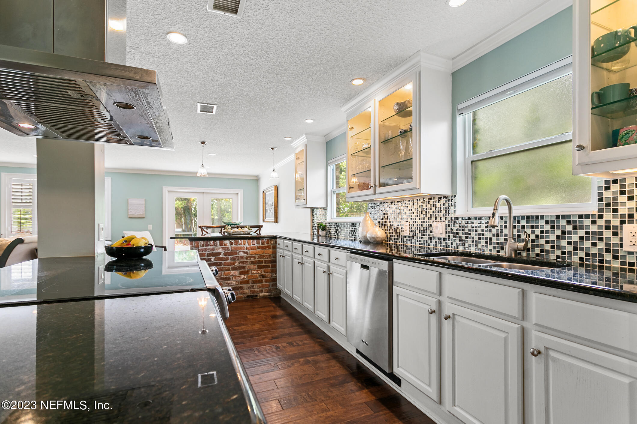 1 Hopson Road Jacksonville Beach, FL 32250 - Photo 13 of 58 a large white kitchen with lots of counter space and windows