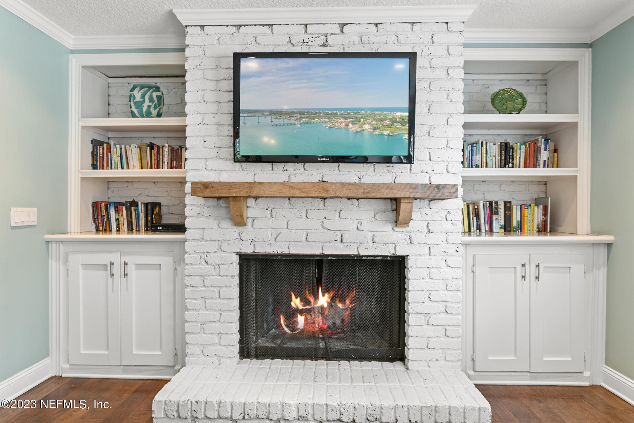 1 Hopson Road Jacksonville Beach, FL 32250 - Photo 24 of 58 a living room with fireplace and a flat screen tv