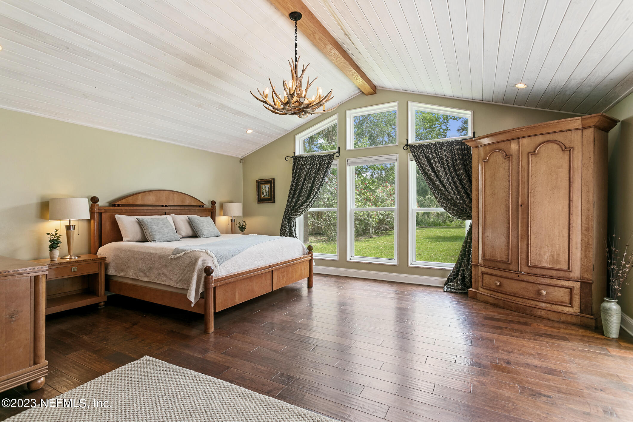 1 Hopson Road Jacksonville Beach, FL 32250 - Photo 33 of 58 a bedroom with a bed a table and a large window