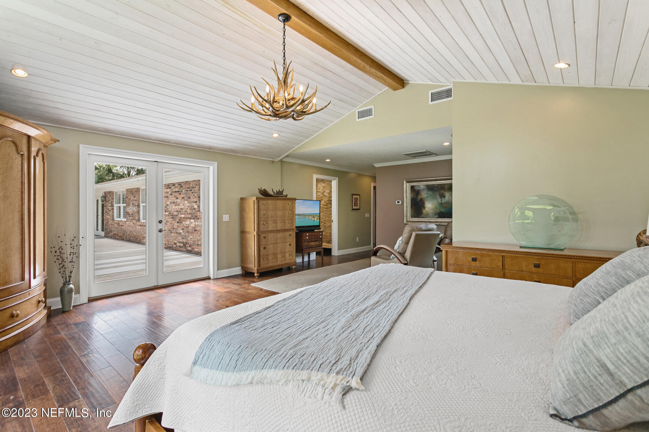 1 Hopson Road Jacksonville Beach, FL 32250 - Photo 36 of 58 a bed room with a bed and a chandelier