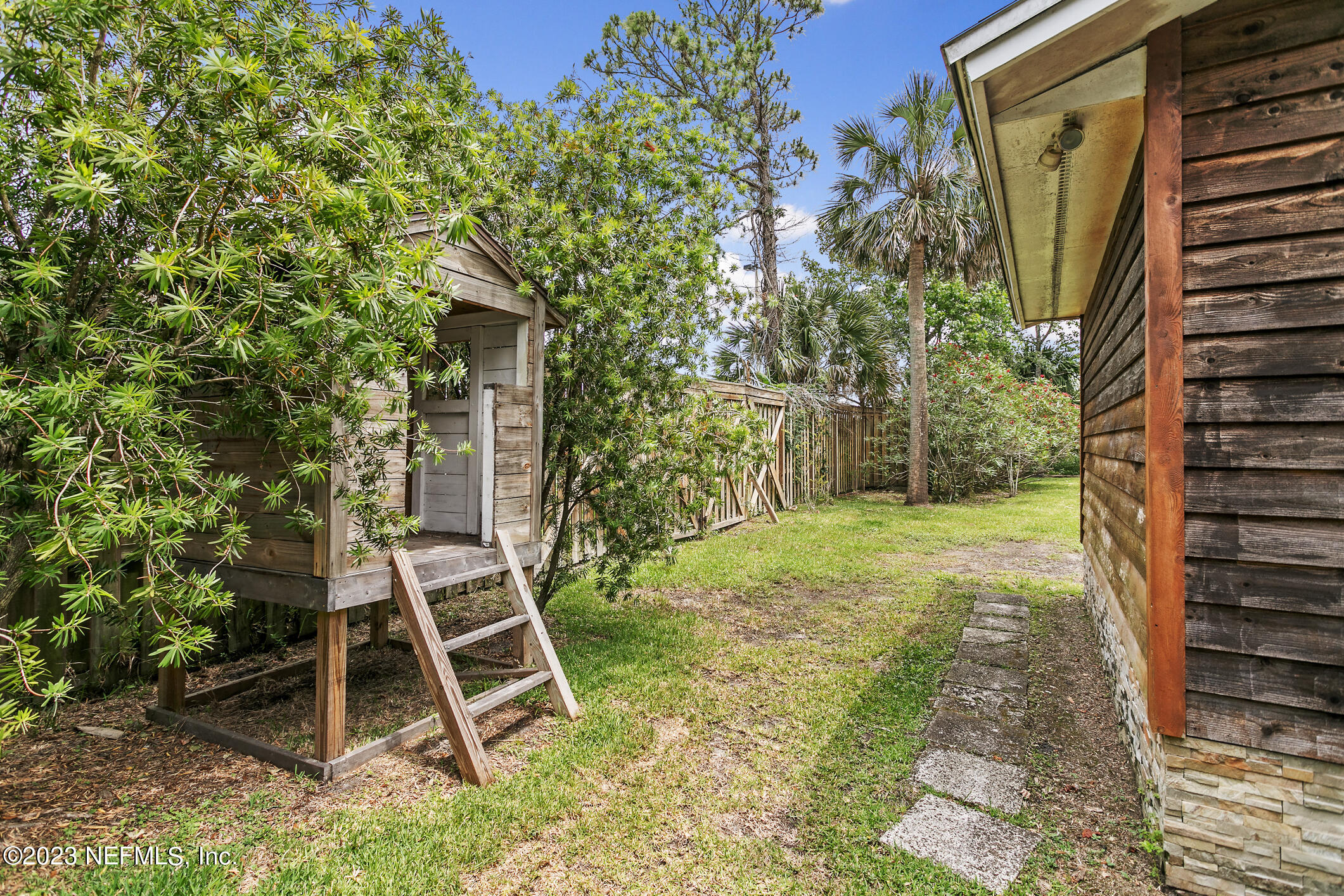 1 Hopson Road Jacksonville Beach, FL 32250 - Photo 41 of 58 a backyard of a house with table and chairs