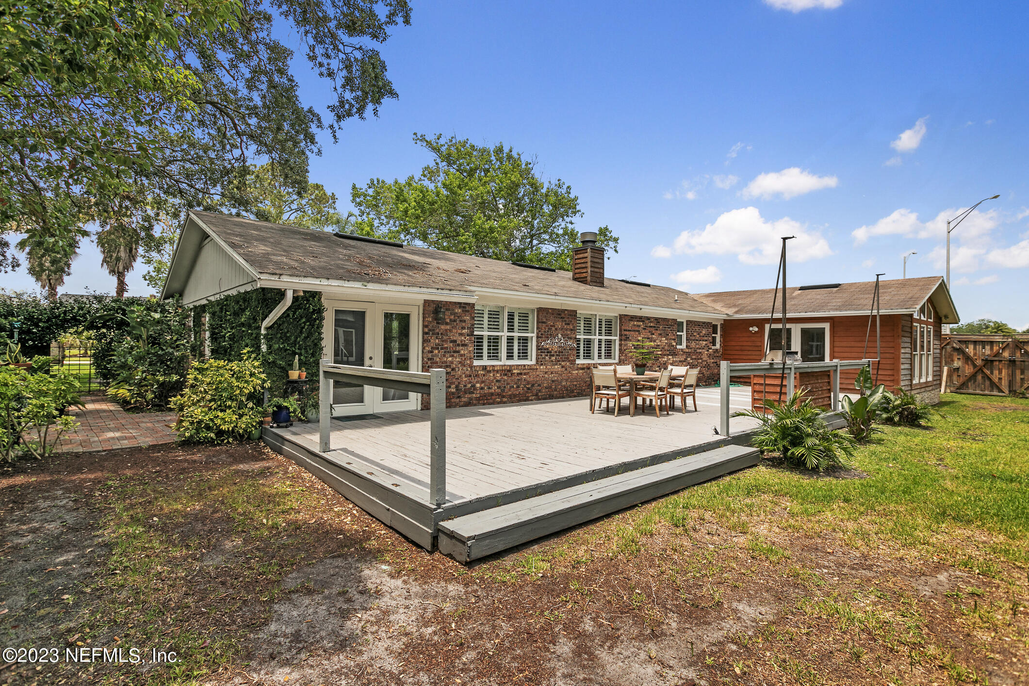1 Hopson Road Jacksonville Beach, FL 32250 - Photo 46 of 58 a front view of a house with a yard table and chairs