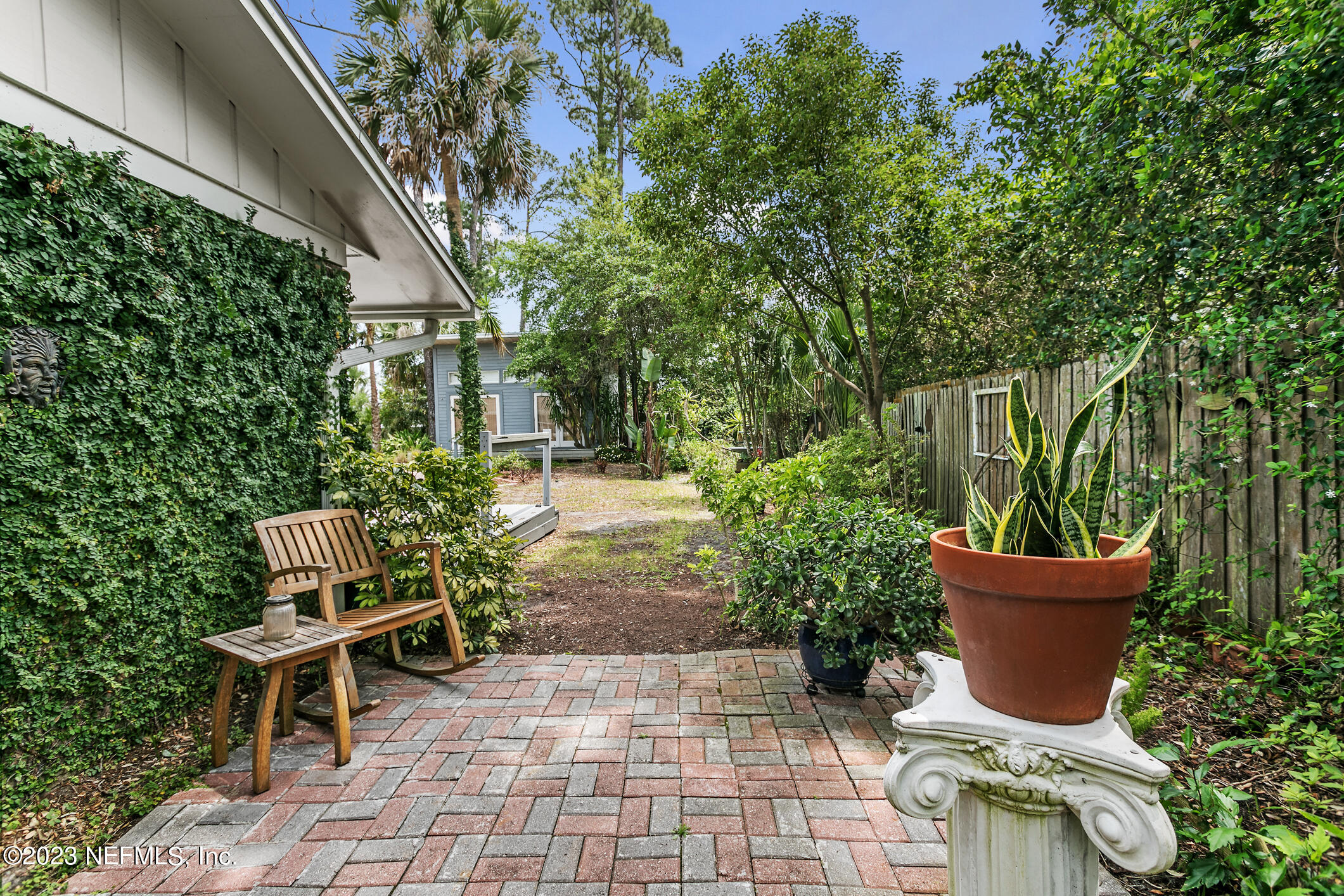 1 Hopson Road Jacksonville Beach, FL 32250 - Photo 48 of 58 a wooden bench sitting in backside of a house