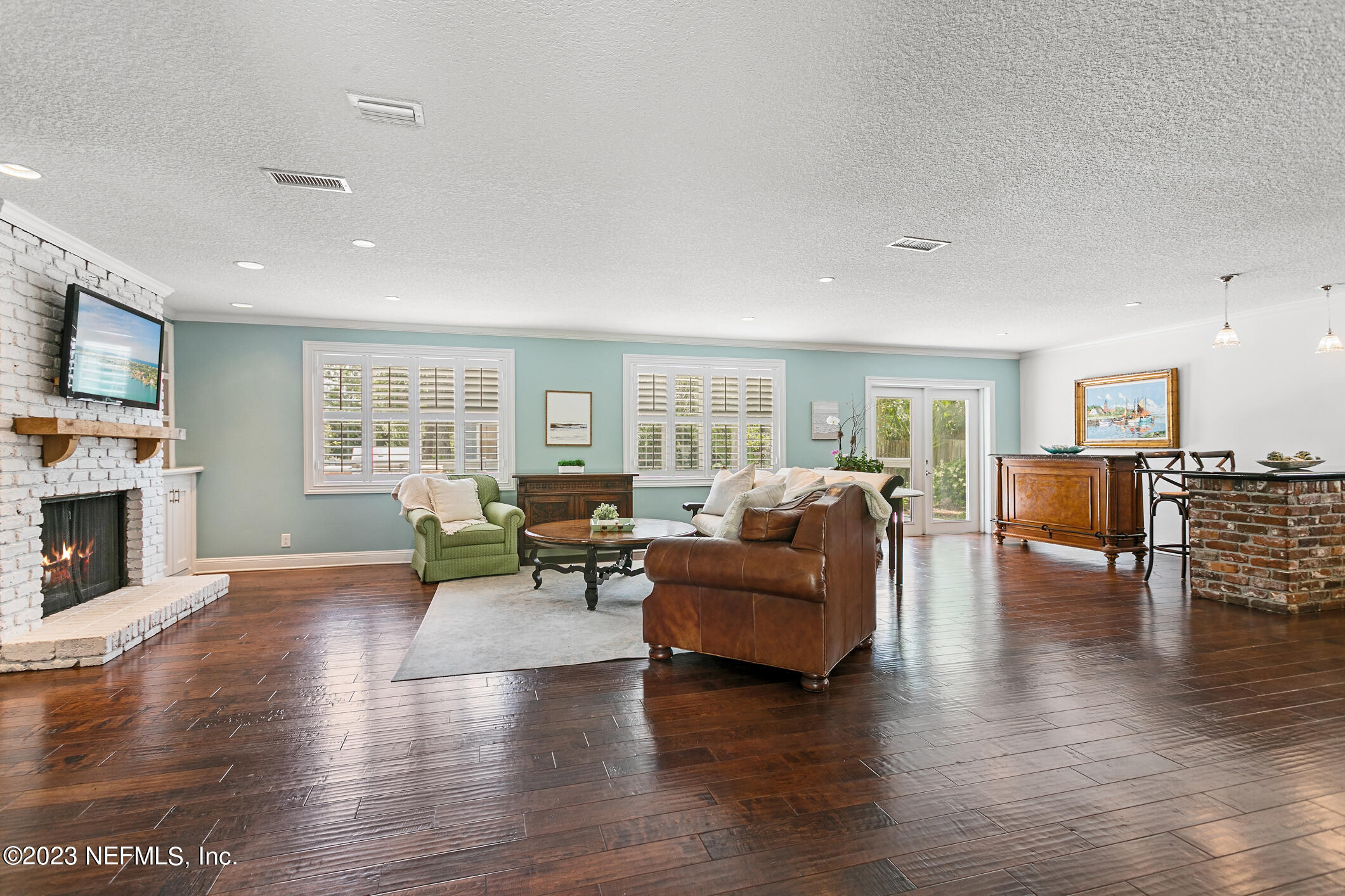1 Hopson Road Jacksonville Beach, FL 32250 - Photo 9 of 58 a living room with fireplace furniture and a wooden floor