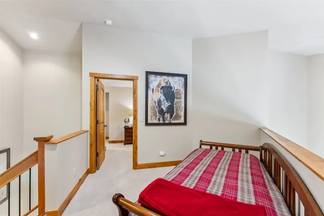 a bedroom with a bed and dresser with mirror