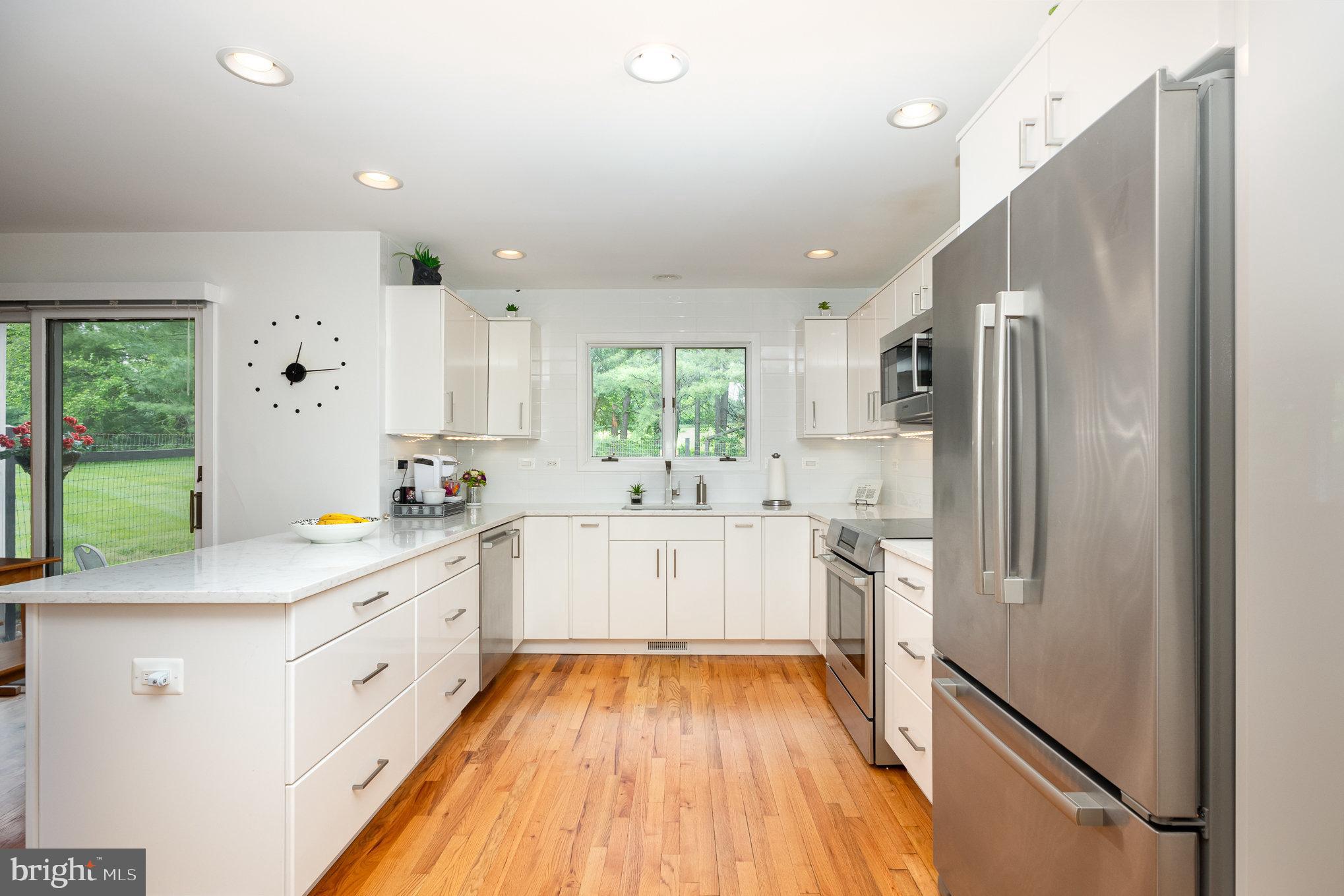 16222 Hampton Road Hamilton, VA 20158 - Photo 11 of 35 a large kitchen with stainless steel appliances a refrigerator sink and white cabinets