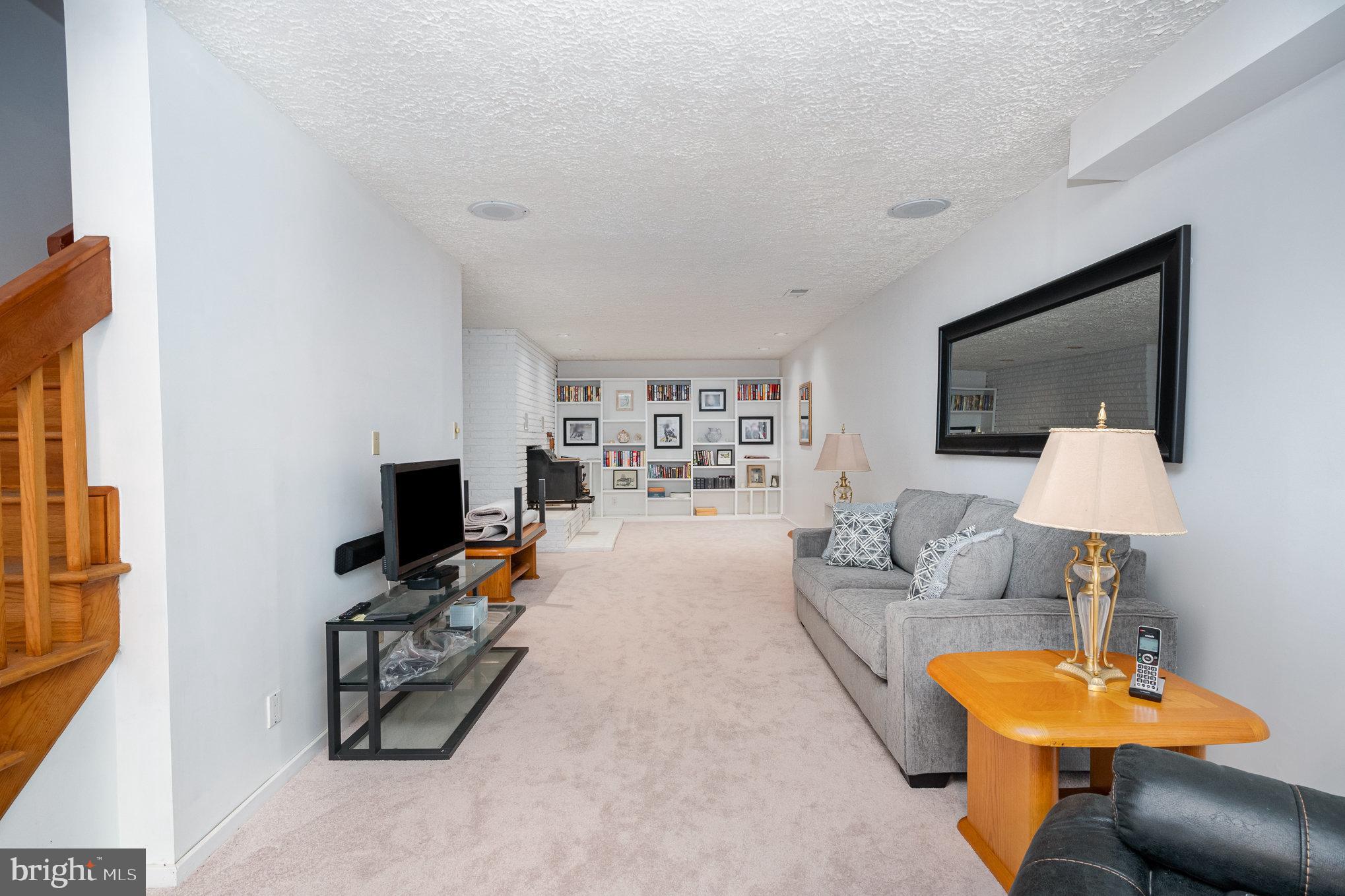 16222 Hampton Road Hamilton, VA 20158 - Photo 29 of 35 a living room with furniture a lamp and a flat screen tv