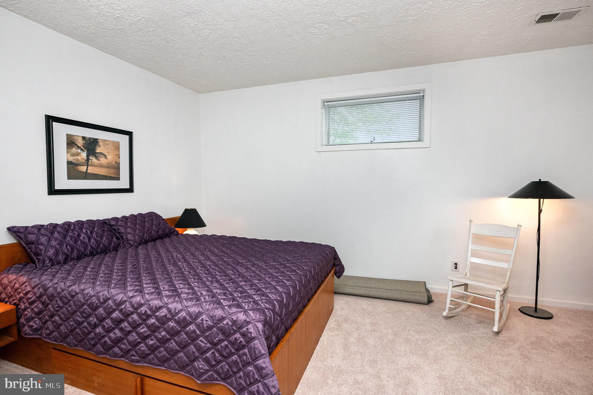 16222 Hampton Road Hamilton, VA 20158 - Photo 31 of 35 a bedroom with a bed and painting on the wall