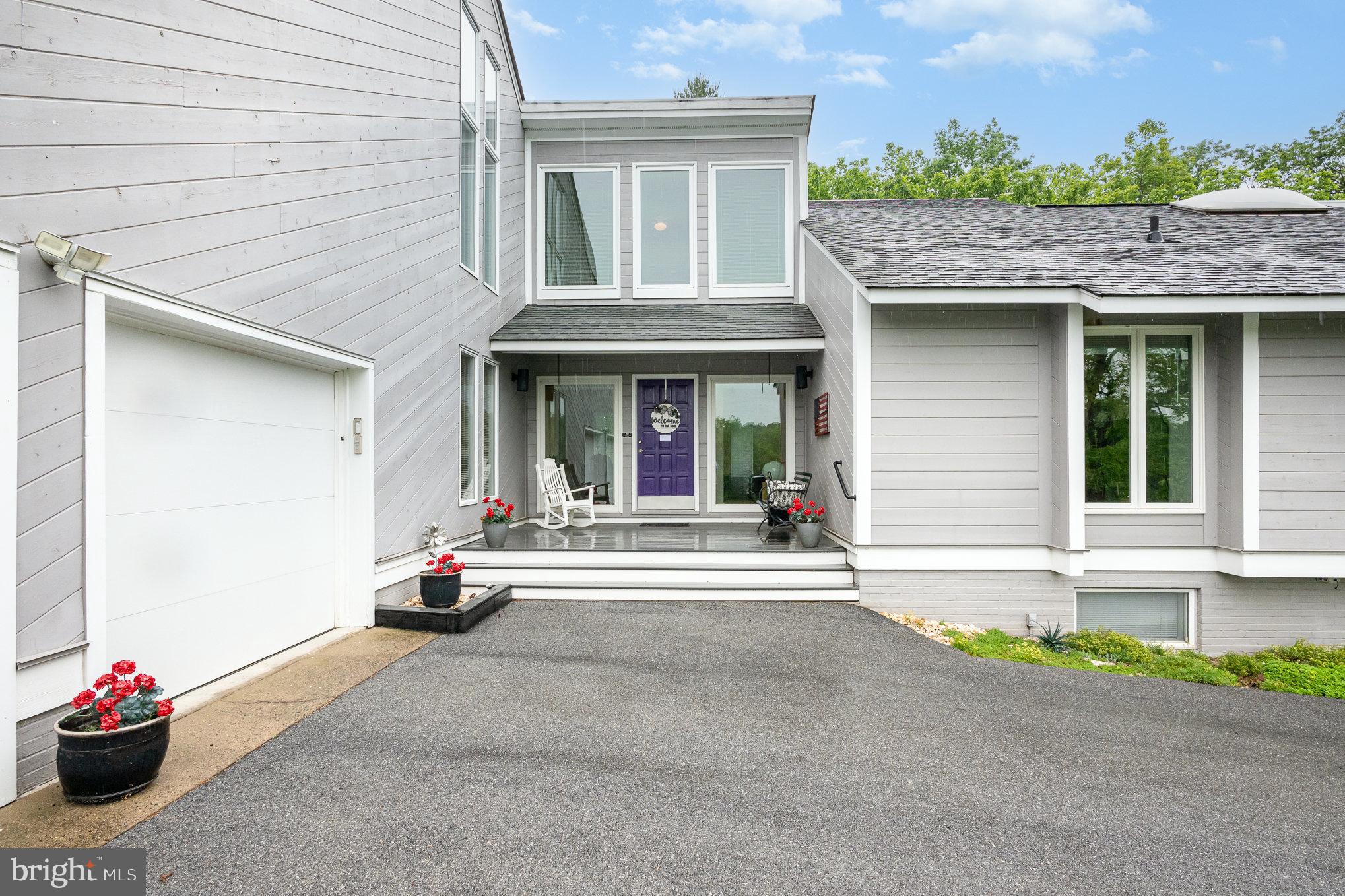 16222 Hampton Road Hamilton, VA 20158 - Photo 4 of 35 a view of brick house with potted plants and a table and chairs