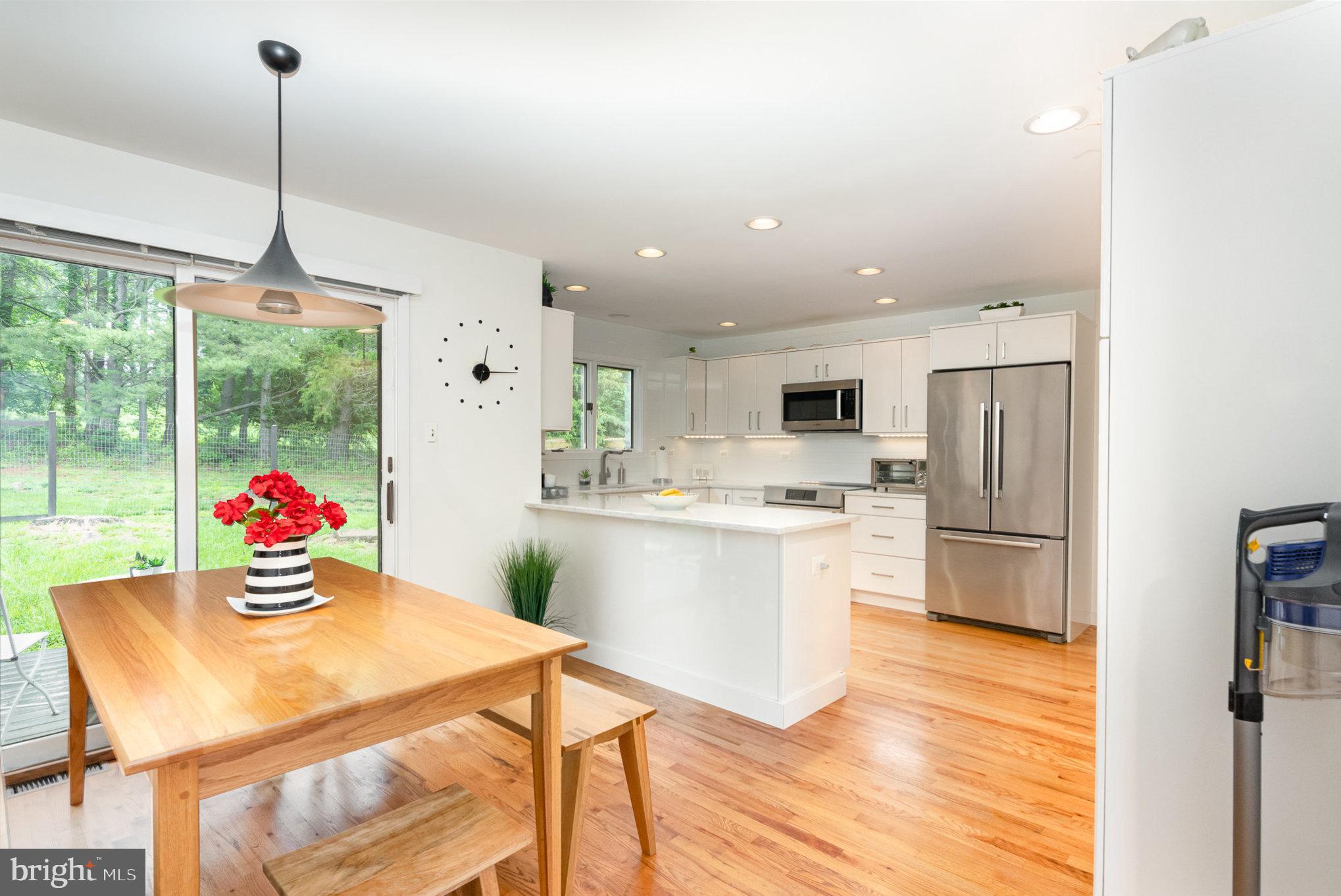 16222 Hampton Road Hamilton, VA 20158 - Photo 10 of 35 a kitchen with stainless steel appliances granite countertop a refrigerator a sink dishwasher a oven with white cabinets and wooden floor