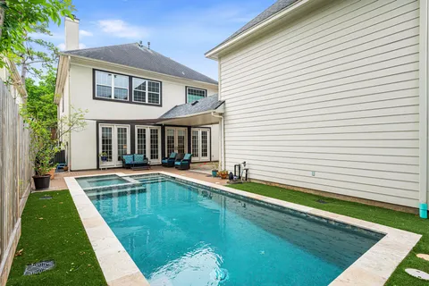 a view of a house with swimming pool and sitting area