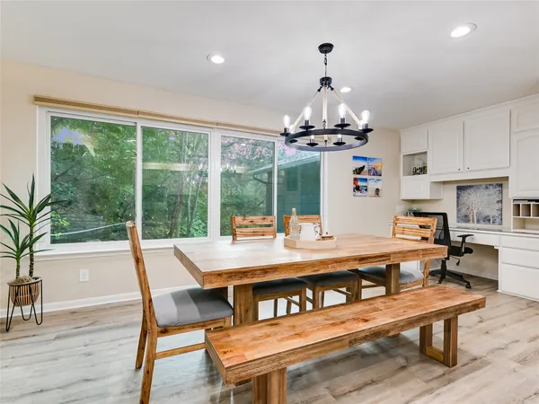 a view of a dining room with furniture wooden floor and chandelier