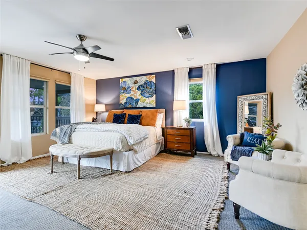 a bedroom with a bed a couch and a window