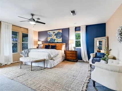 a bedroom with a bed a couch and dresser