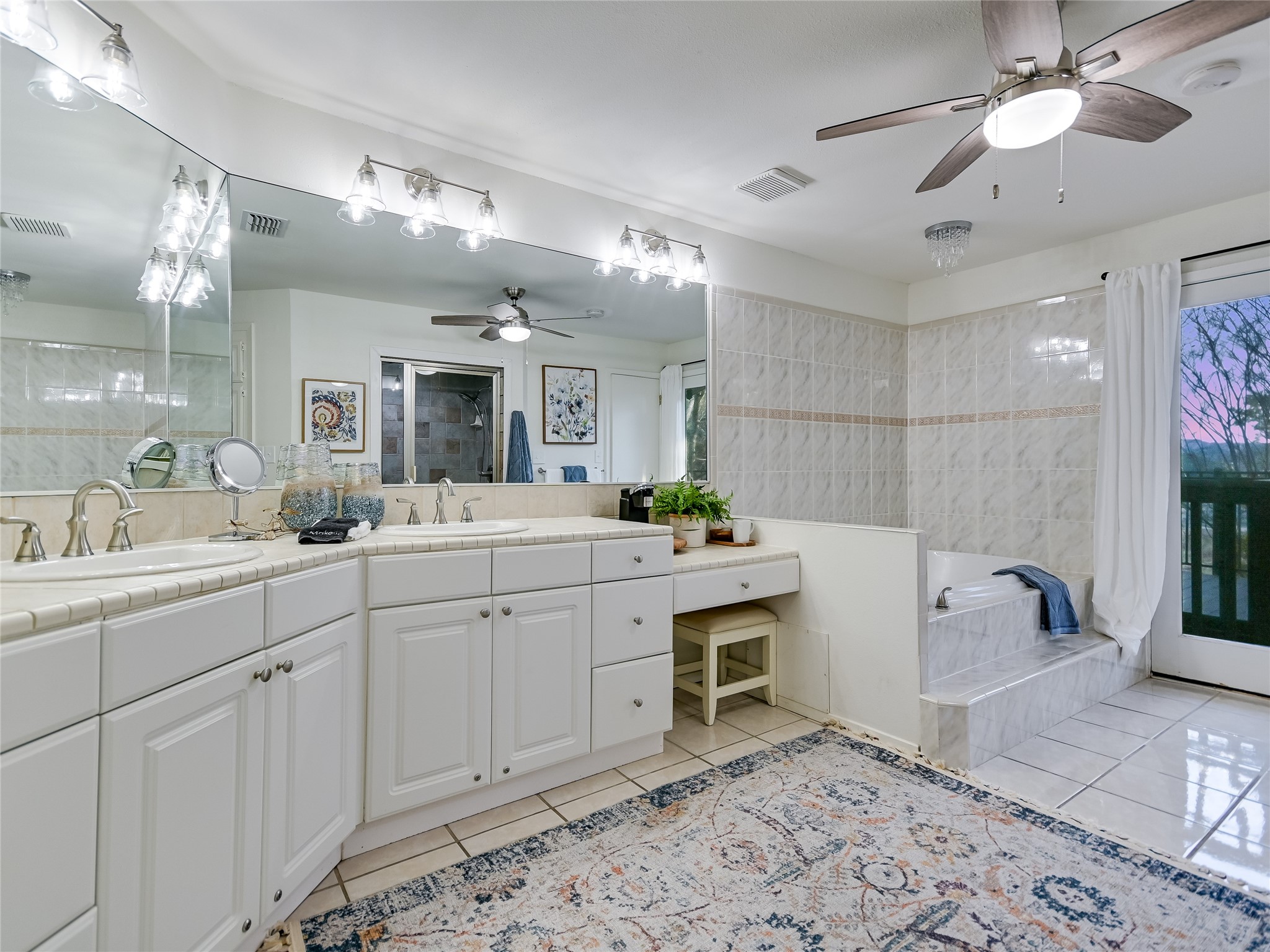 13401 Bullick Hollow Road Austin, TX 78726 - Photo 26 of 40 a spacious bathroom with a sink a large mirror and shower