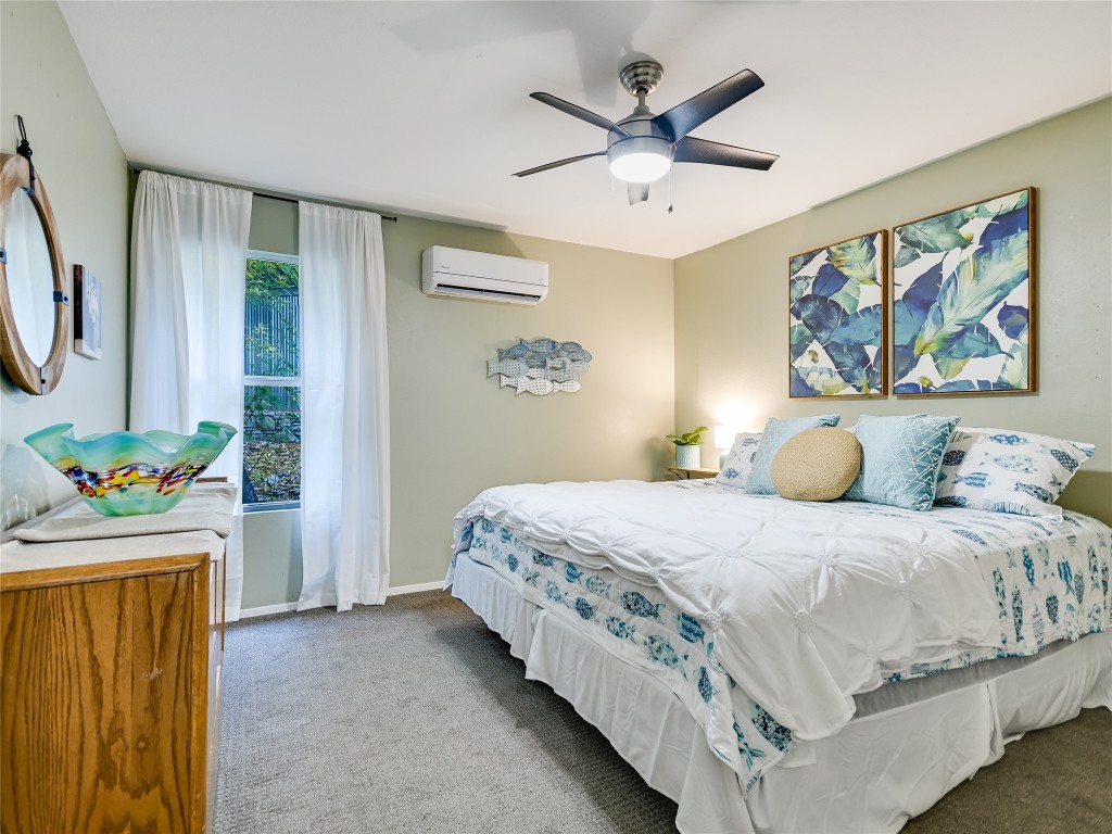 13401 Bullick Hollow Road Austin, TX 78726 - Photo 27 of 40 a bedroom with a bed a wall painting and a window