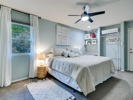 a bedroom with a bed and a ceiling fan