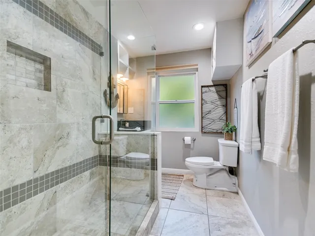 a bathroom with a toilet a sink and a shower