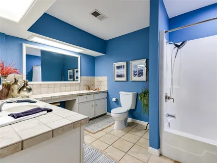 a room with a sink and chairs