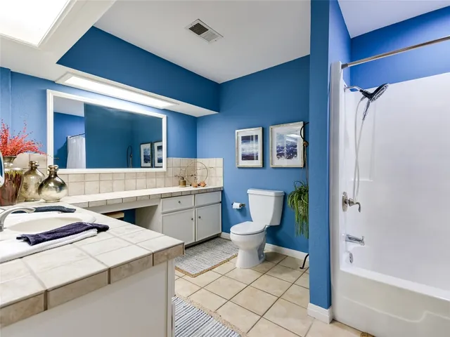 a room with a sink and chairs