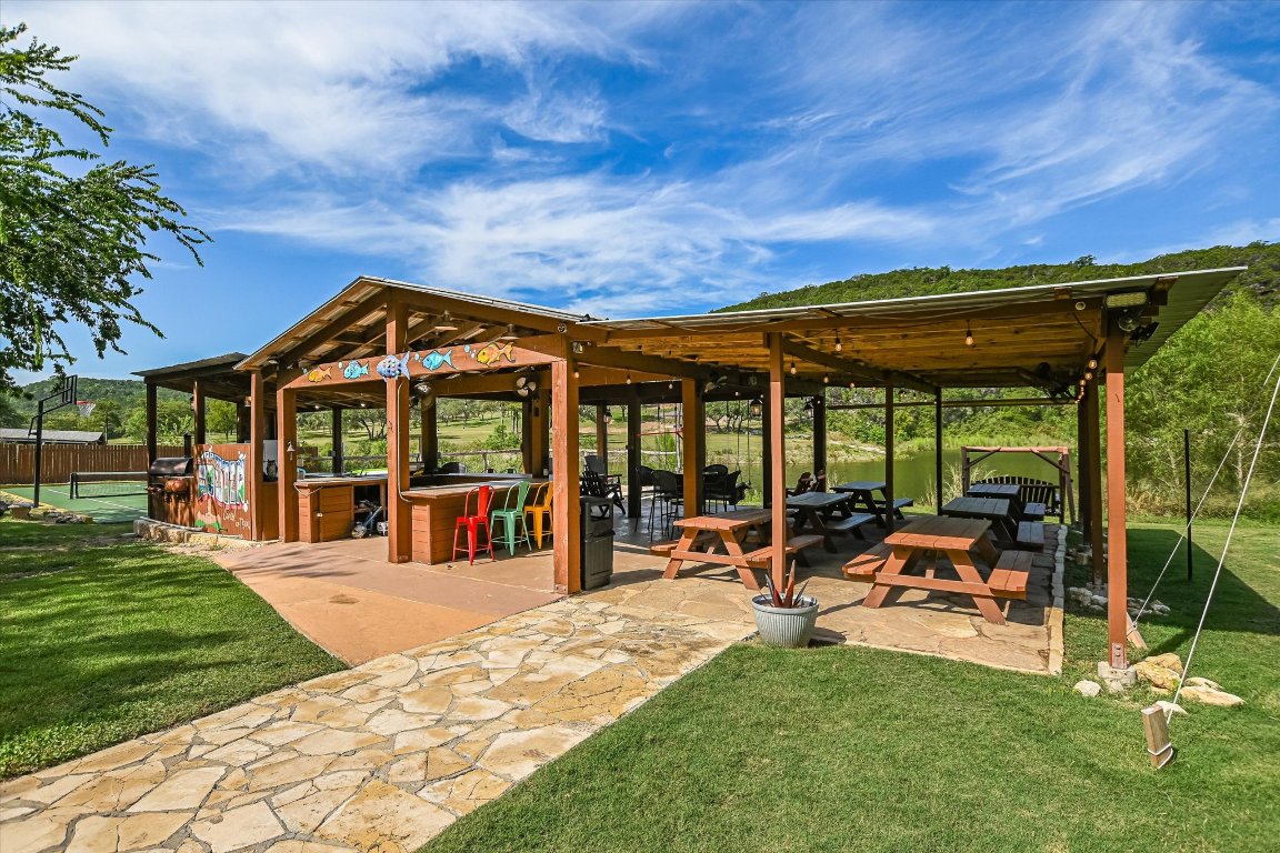 13401 Bullick Hollow Road Austin, TX 78726 - Photo 9 of 40 a patio with a table and chairs under an umbrella