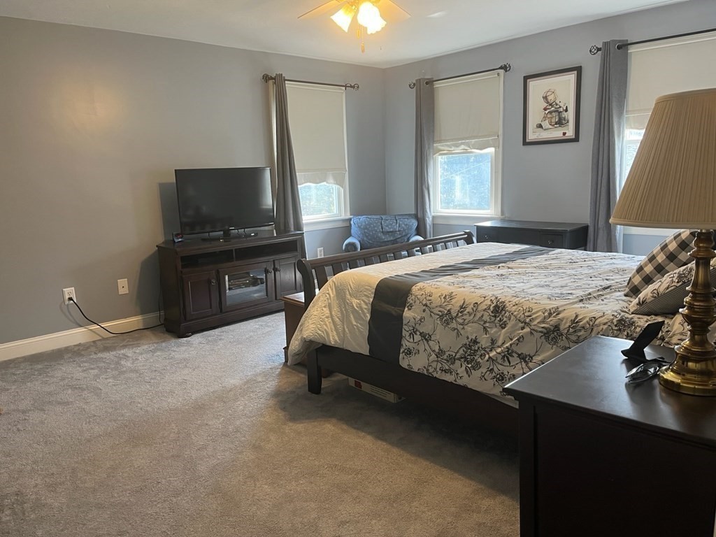 60 Marble Road Sutton, MA 01590 - Photo 14 of 21 a bedroom with a bed and a flat tv screen on the dresser
