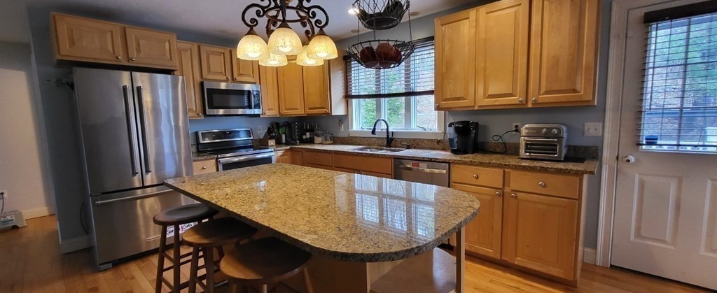 60 Marble Road Sutton, MA 01590 - Photo 8 of 21 a kitchen with stainless steel appliances granite countertop a sink refrigerator stove and microwave