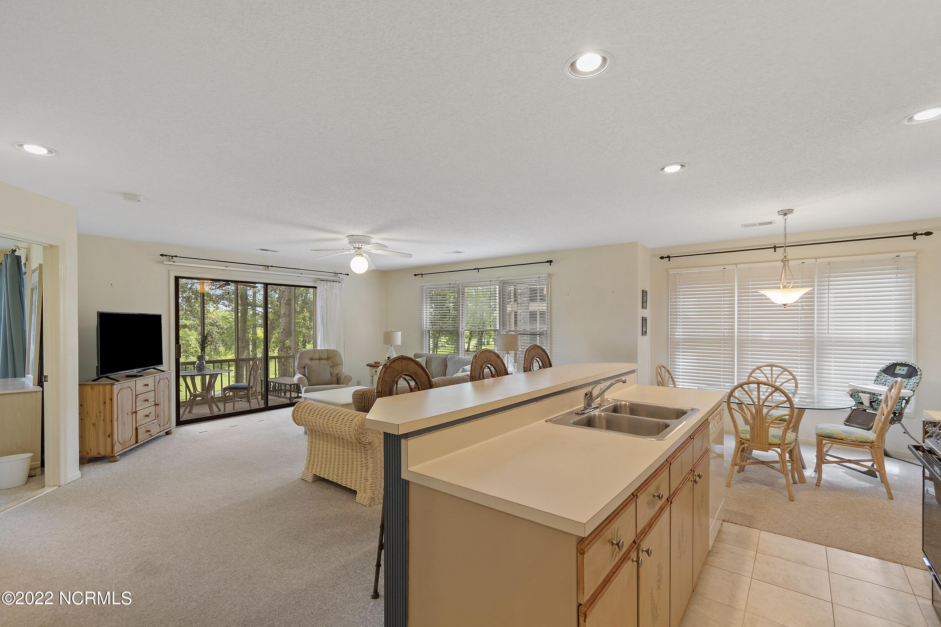 223 Clubhouse Road, Unit 4 Sunset Beach, NC 28468 - Photo 3 of 42 Villa kitchen to living