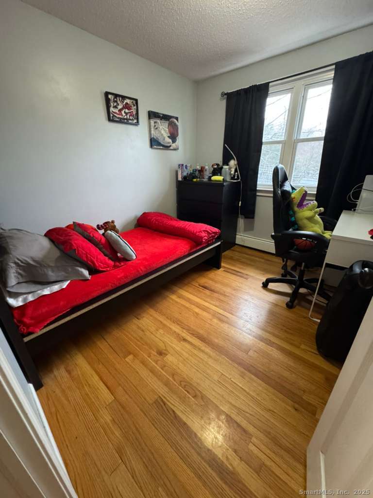 158 Swain Avenue Meriden, CT 06450 - Photo 18 of 25 a bedroom with a bed and a dresser next to a window