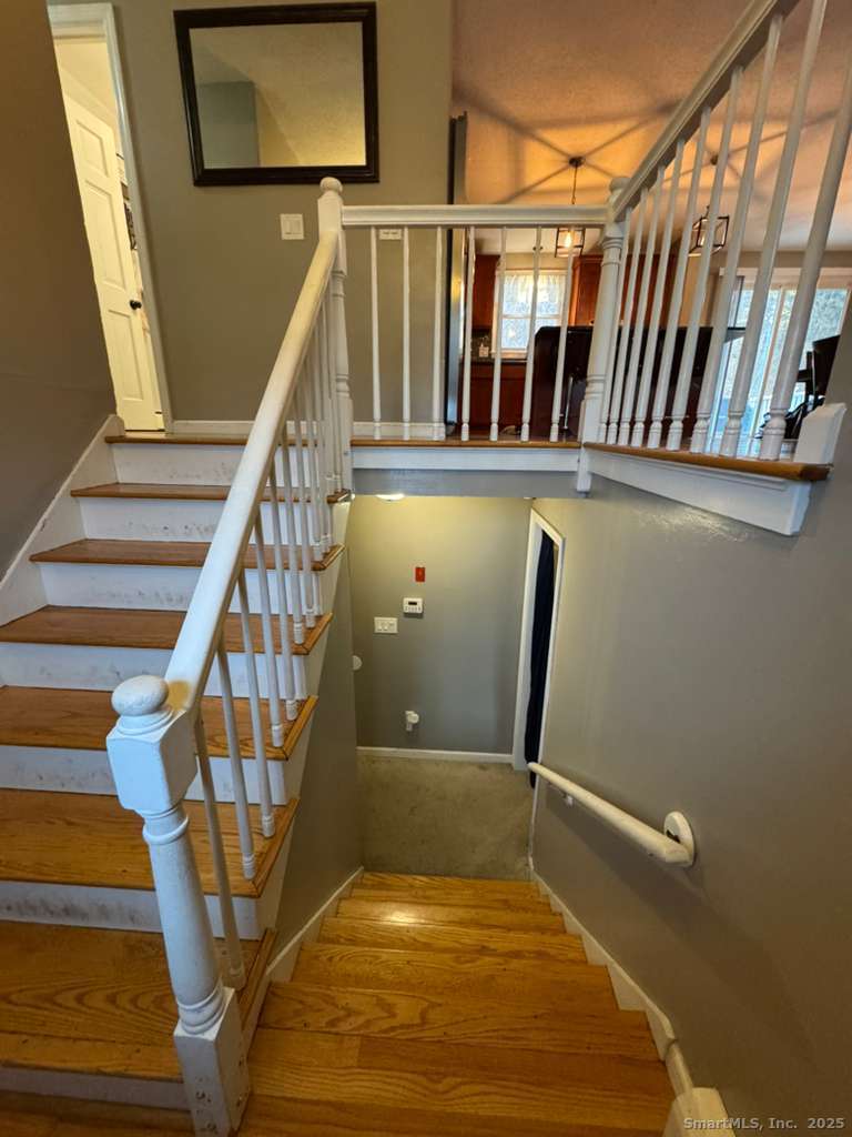 158 Swain Avenue Meriden, CT 06450 - Photo 19 of 25 a view of a hallway with wooden floor and stairs