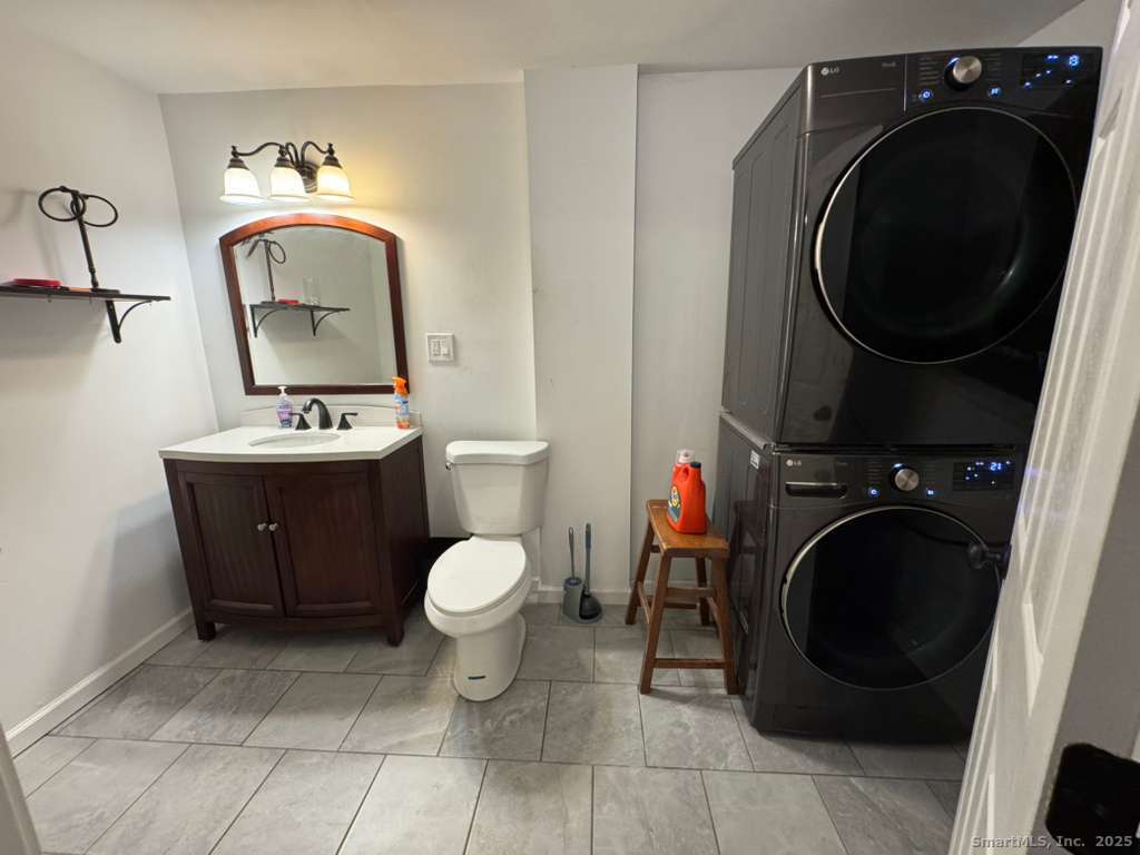 158 Swain Avenue Meriden, CT 06450 - Photo 21 of 25 a bathroom with a toilet a sink and washing machine