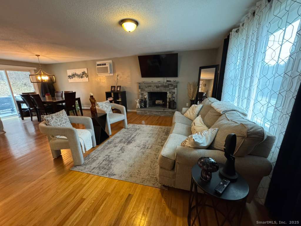 158 Swain Avenue Meriden, CT 06450 - Photo 7 of 25 a living room with furniture fireplace and a flat screen tv