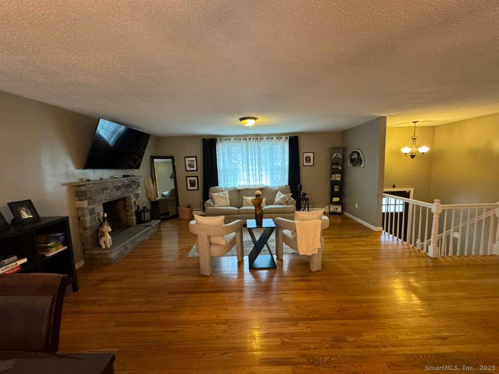 158 Swain Avenue Meriden, CT 06450 - Photo 8 of 25 a living room with fireplace furniture and a flat screen tv