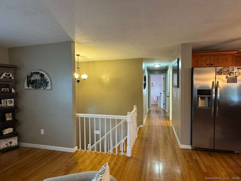 158 Swain Avenue Meriden, CT 06450 - Photo 10 of 25 a view of a hallway with wooden floor