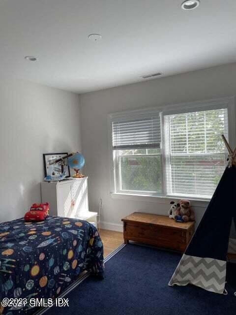 8 Sound Beach Ave Extension, Unit 2 Riverside, CT 06878 - Photo 17 of 29 a bedroom with a bed and a window