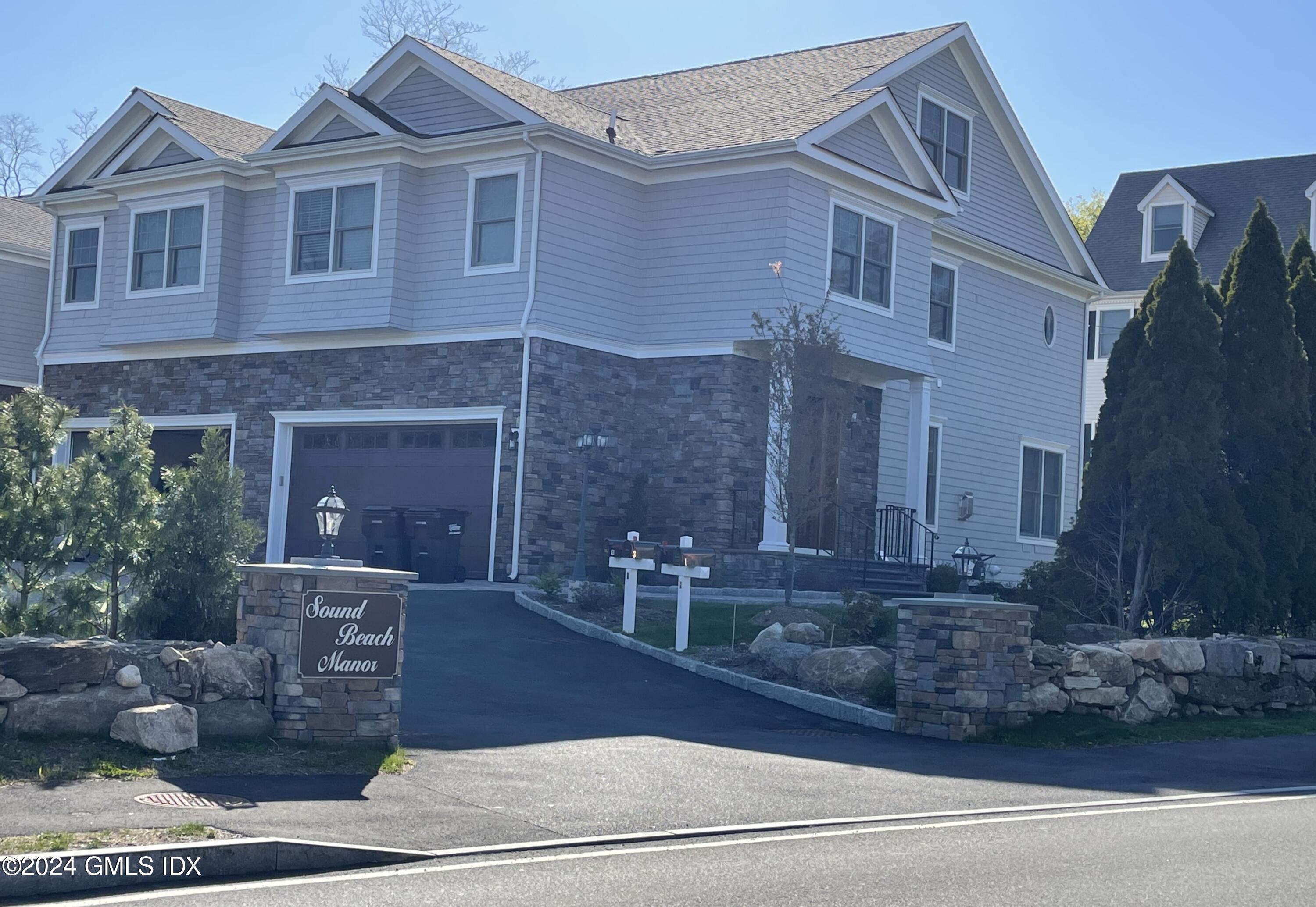 8 Sound Beach Ave Extension, Unit 2 Riverside, CT 06878 - Photo 3 of 29 a front view of a house with garden