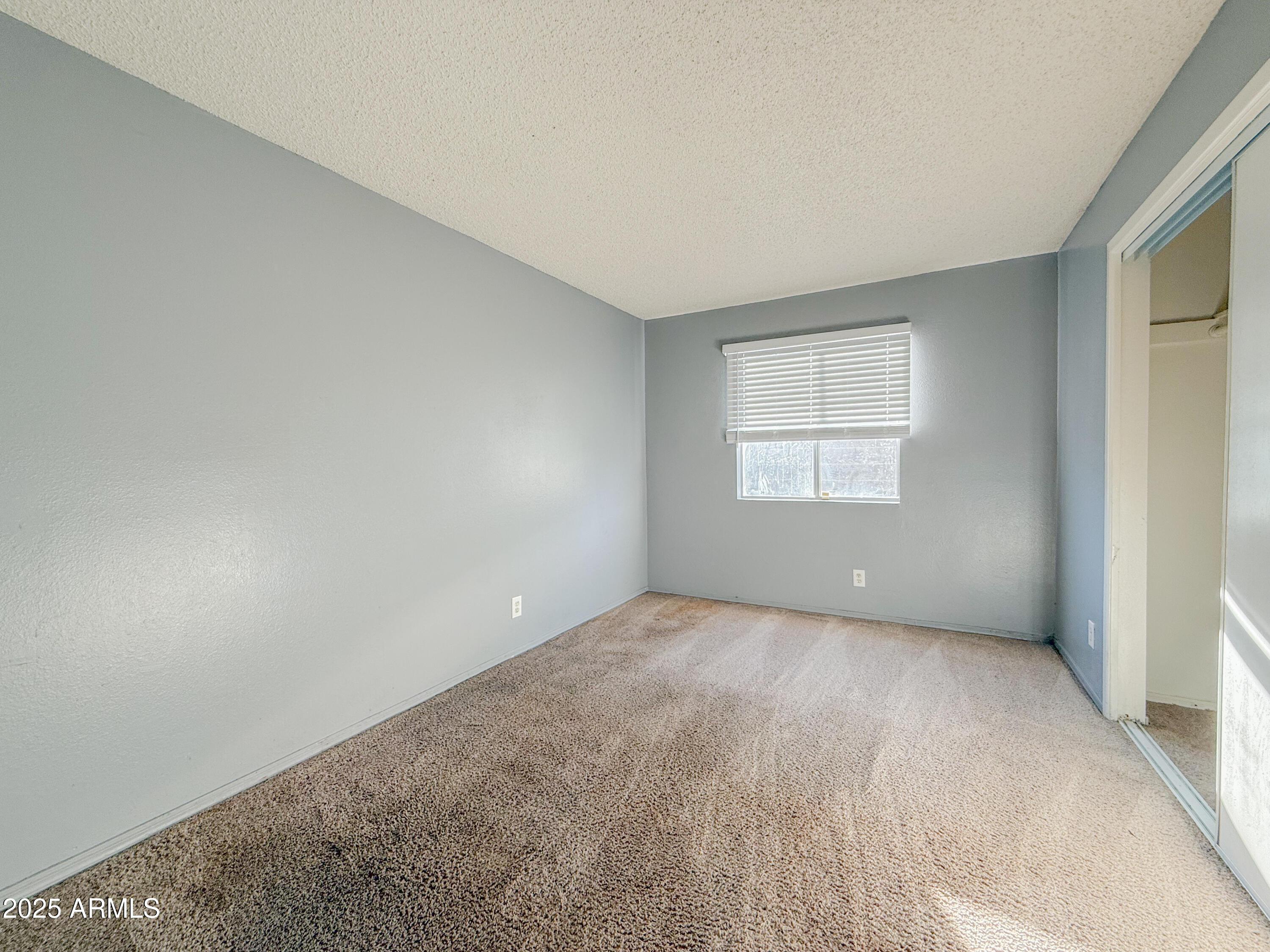 15601 North 27th Street, Unit 14 Phoenix, AZ 85032 - Photo 13 of 16 a view of an empty room with a window