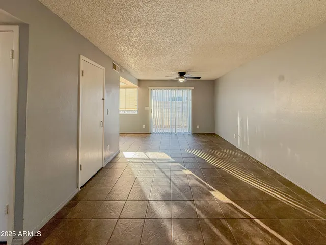 a view of hallway with a couch and chandelier
