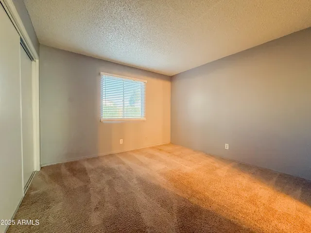 a view of an empty room and a bathroom