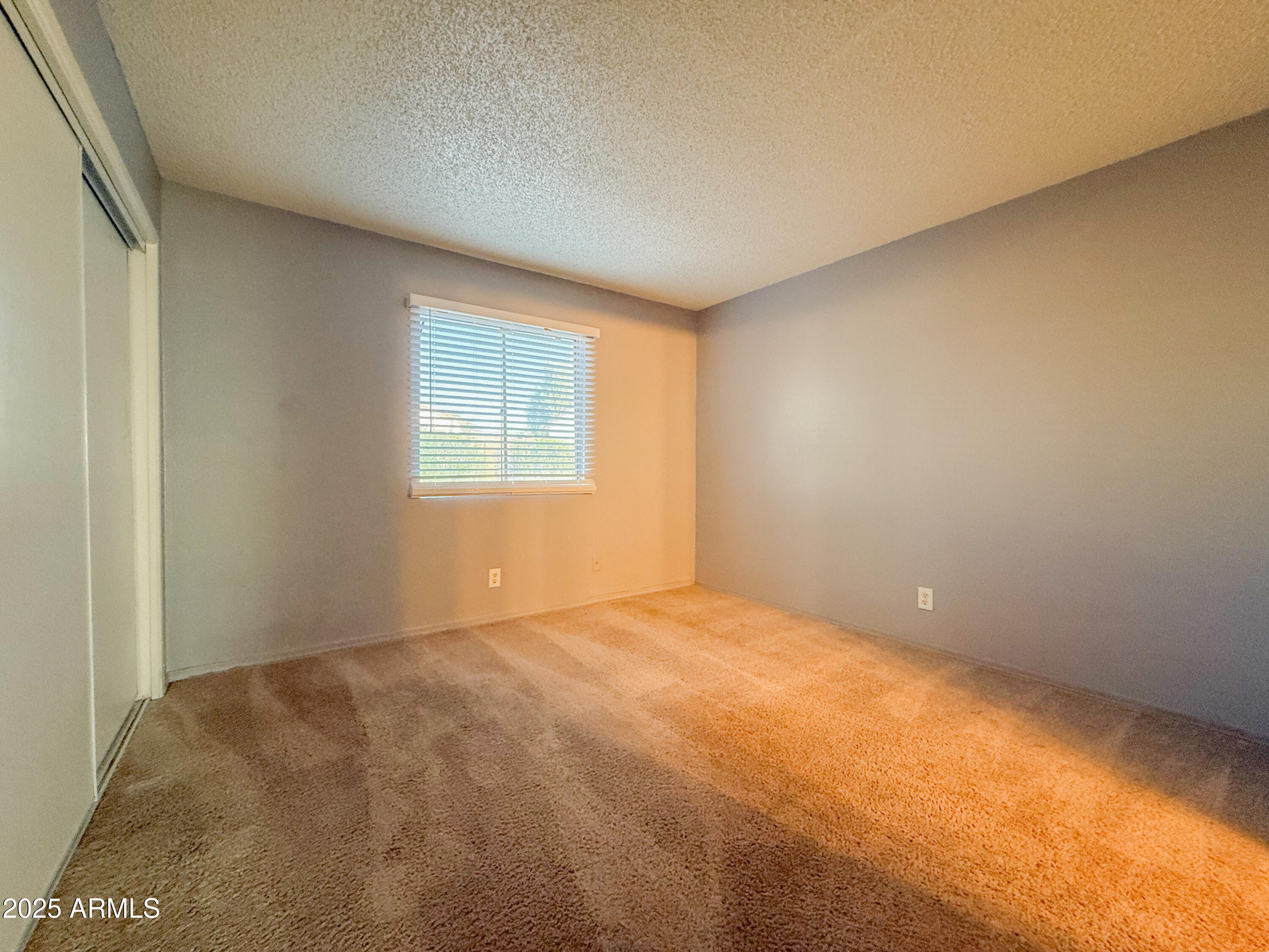 15601 North 27th Street, Unit 14 Phoenix, AZ 85032 - Photo 9 of 16 a view of an empty room with a window
