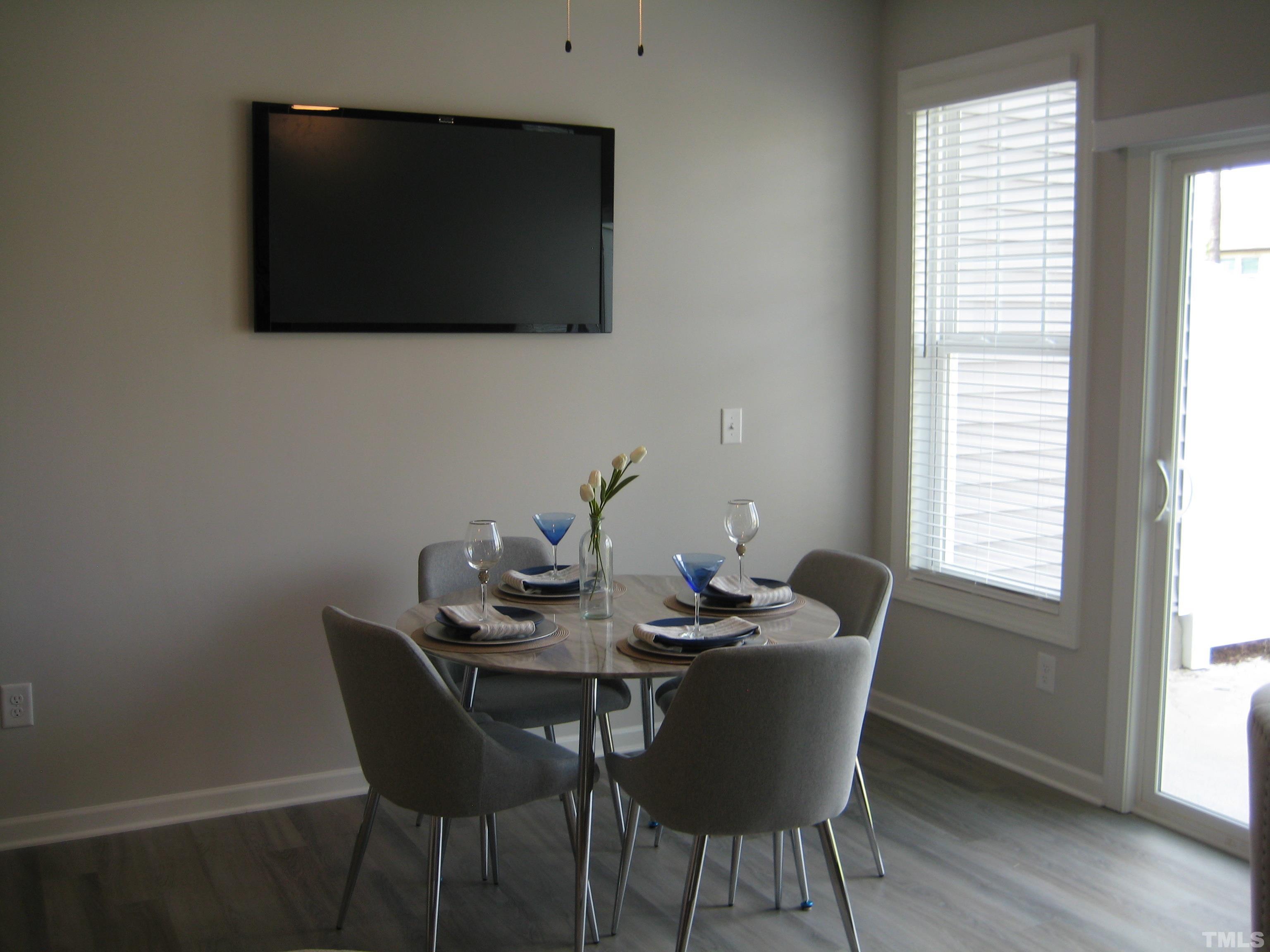 131 Rolesville Ridge Drive Rolesville, NC 27571 - Photo 3 of 8 a dining room with furniture and wooden floor