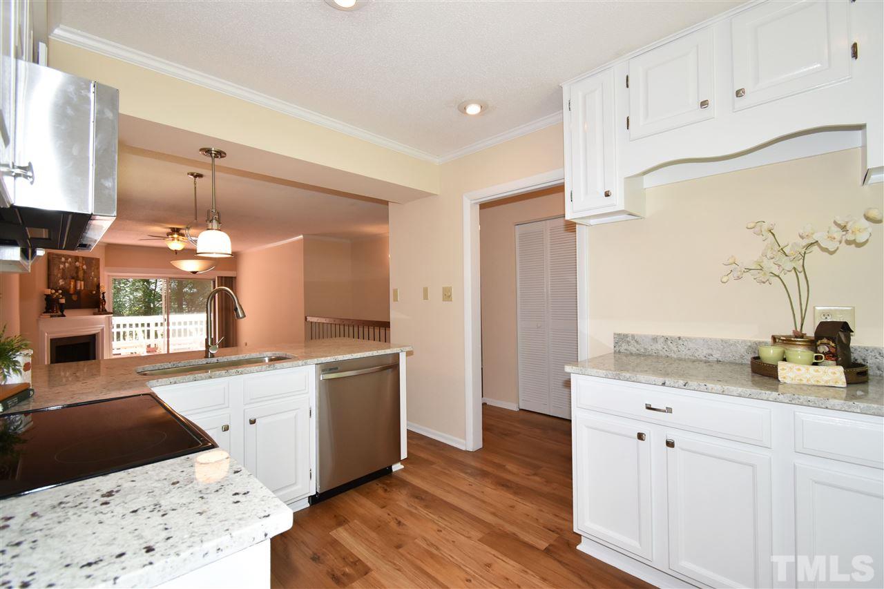 710 Green Ridge Drive Raleigh, NC 27609 - Photo 2 of 26 a kitchen with granite countertop a sink a stove and cabinets