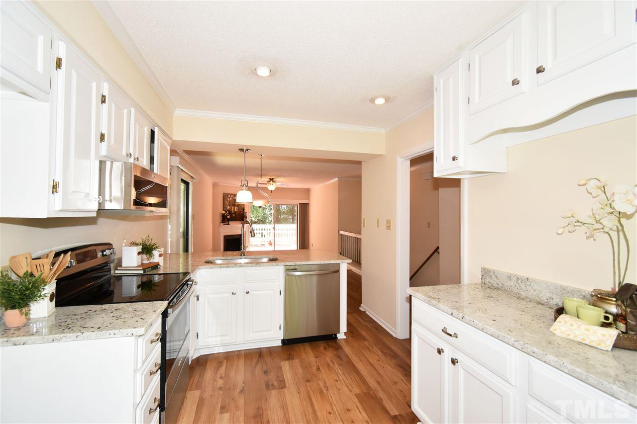 710 Green Ridge Drive Raleigh, NC 27609 - Photo 3 of 26 a kitchen with a sink a stove and cabinets