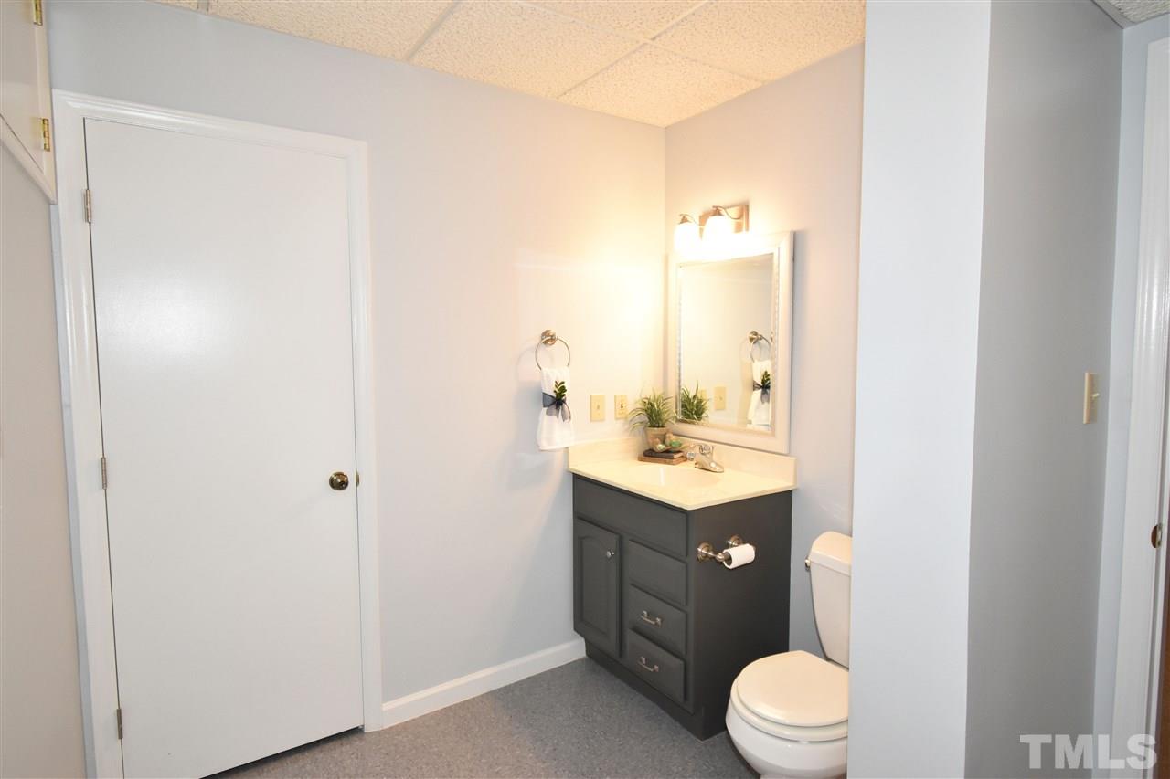 710 Green Ridge Drive Raleigh, NC 27609 - Photo 24 of 26 a bathroom with a sink vanity mirror and toilet