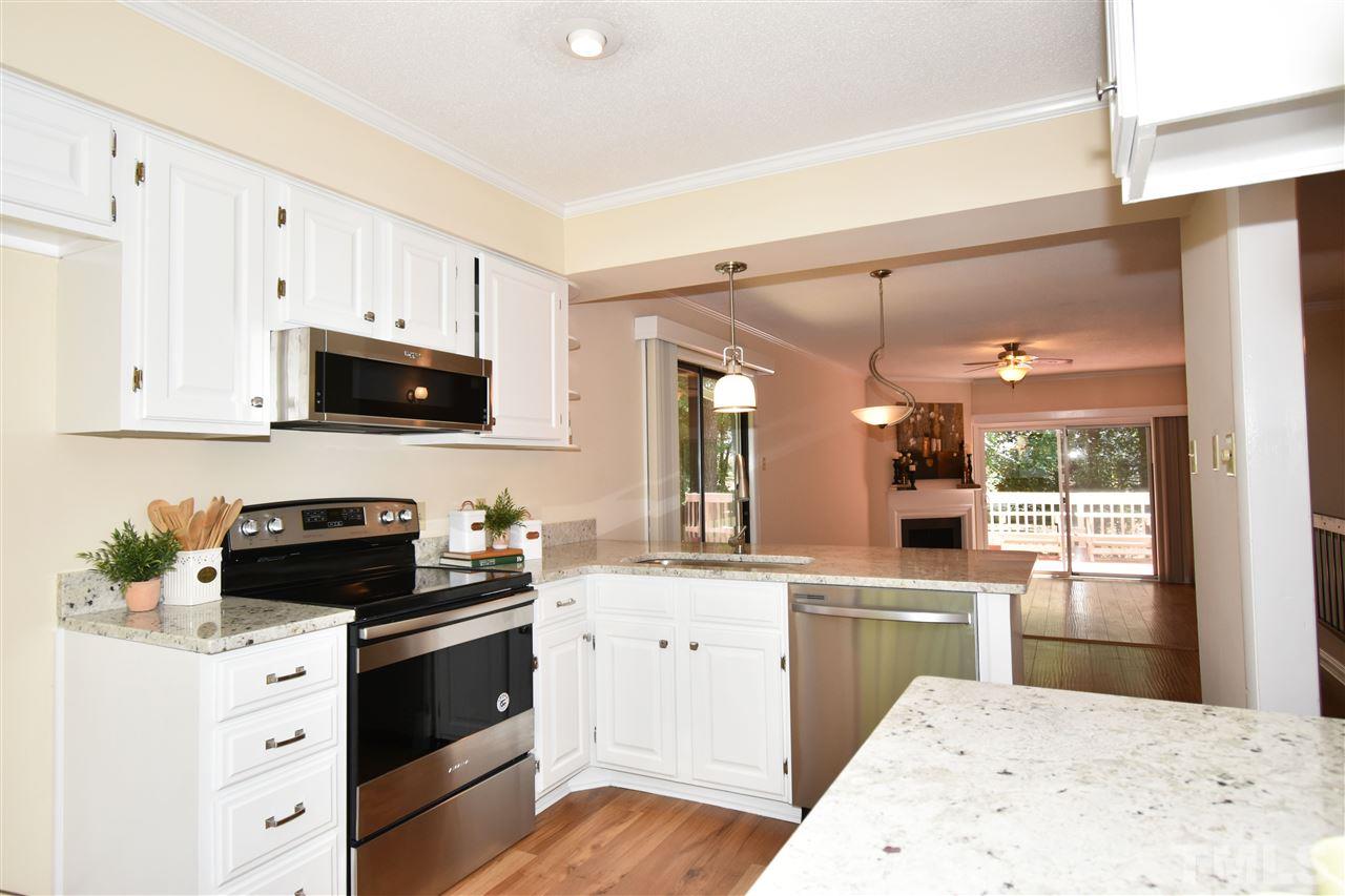 710 Green Ridge Drive Raleigh, NC 27609 - Photo 4 of 26 a kitchen with a sink stove and cabinets