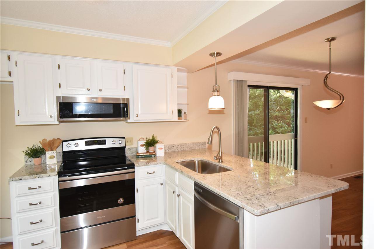 710 Green Ridge Drive Raleigh, NC 27609 - Photo 5 of 26 a kitchen with a sink stove and microwave